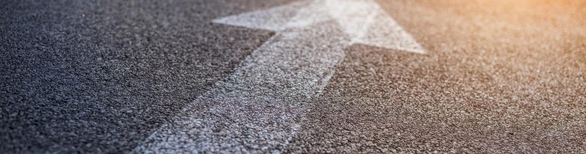arrow on road toward brighter future