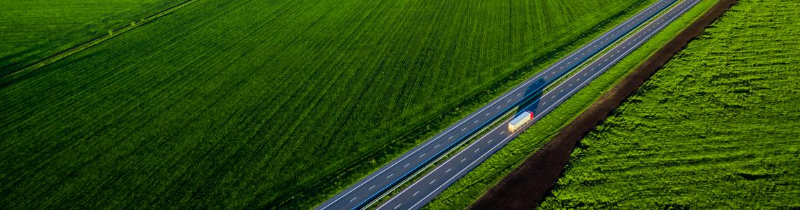 truck on a highway with a green landscape