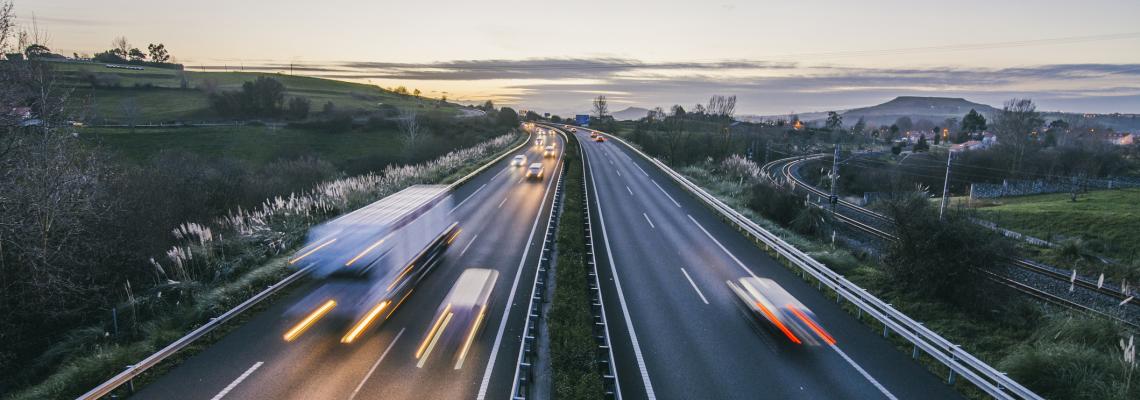 cars speeding on motorway