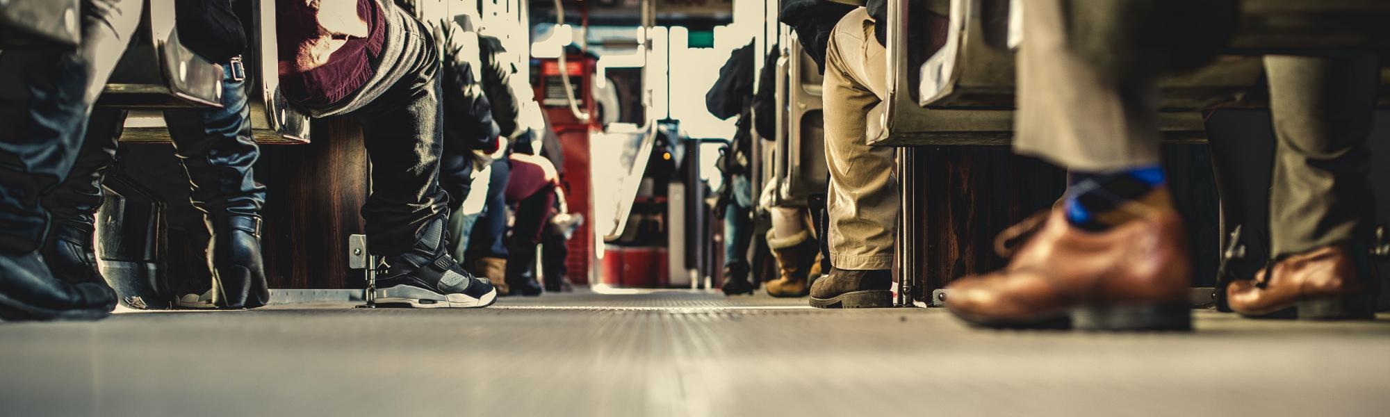 passengers' feet on the floor of a bus 