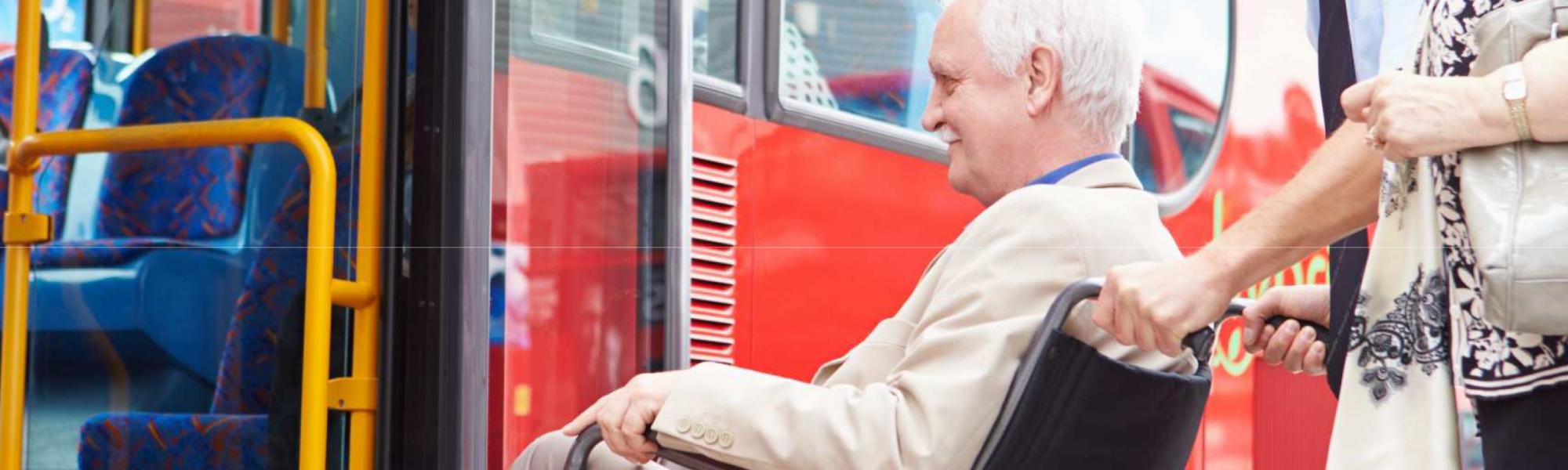 accessibility person in wheelchair getting on bus