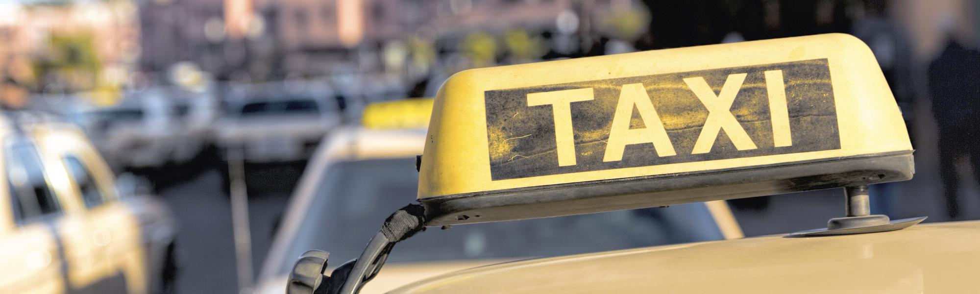 Taxi sign on the roof of the cab