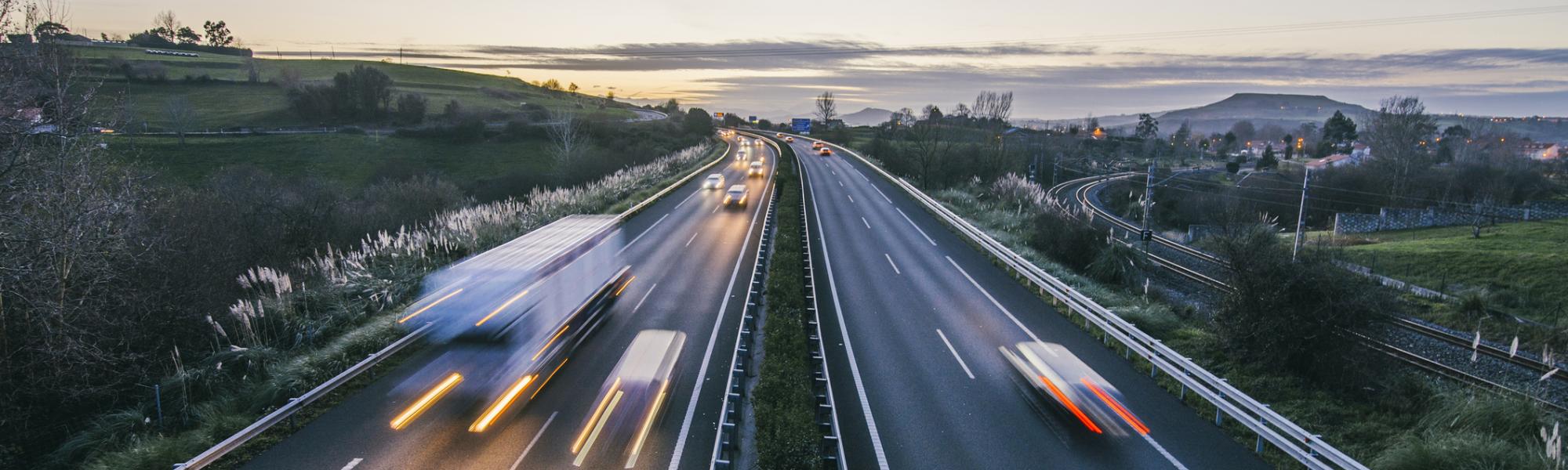 trucks on highway at dusk