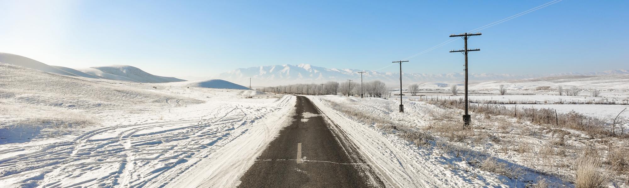 snow on road to mountains