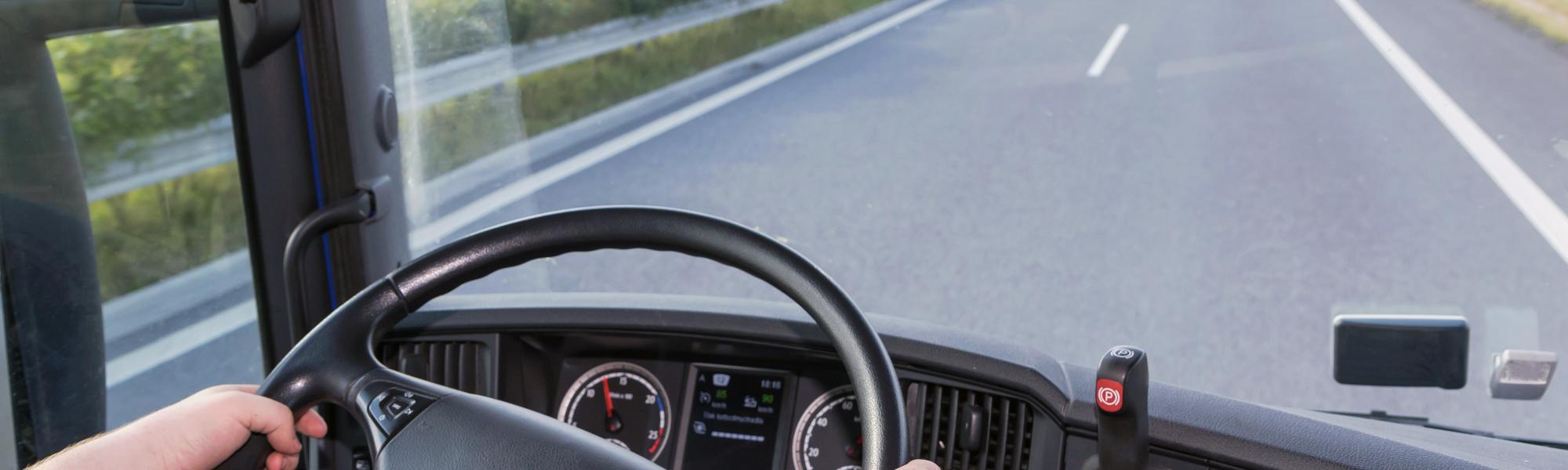 Driver driving its truck on the highway