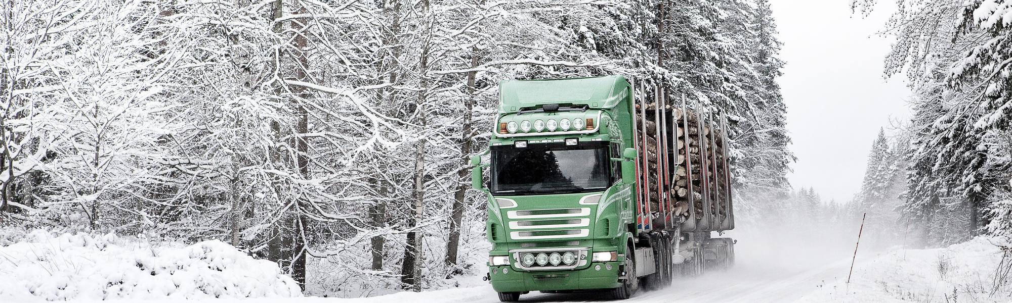 image of a truck on winter road 