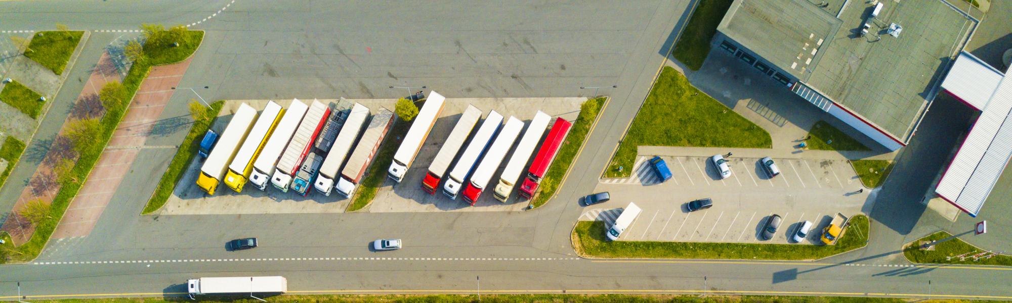 Aerial view of highway rest area with restaurant and large car park for cars and trucks