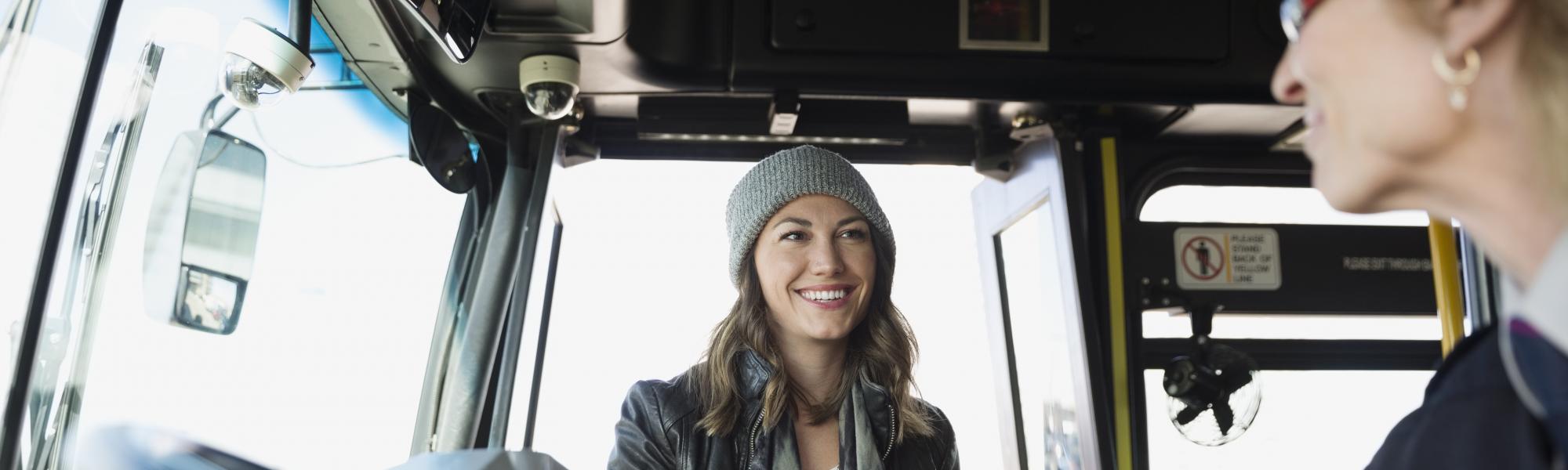 woman giving ticket to bus driver