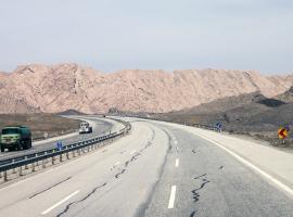 road near Tehran with trucks and road signs