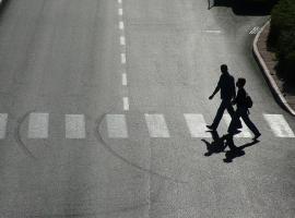 two people crossing the road zebra crossing