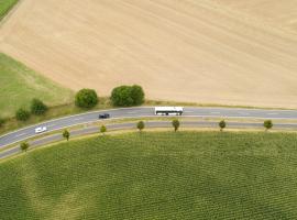 aerial view of a white coach driving on the road